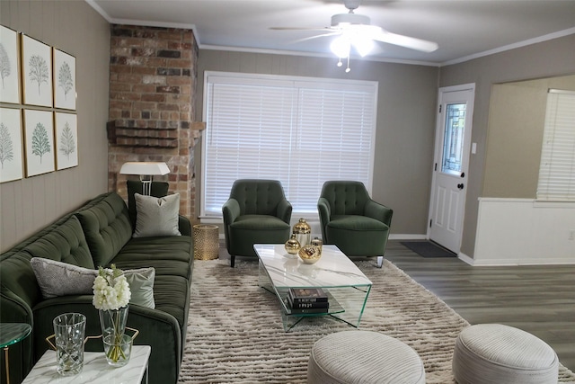 living room with hardwood / wood-style floors, ceiling fan, and crown molding