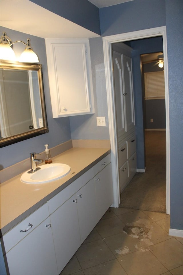 bathroom featuring tile patterned flooring, vanity, and ceiling fan