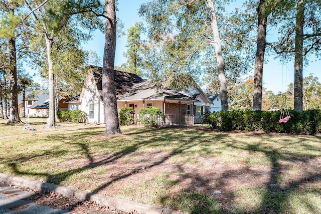 view of front of property with covered porch and a front yard