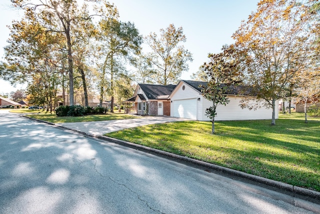 view of front of house with a front yard and a garage