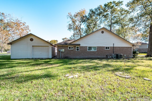 back of property with a lawn and central air condition unit