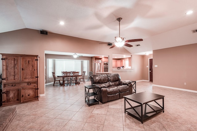 tiled living room featuring ceiling fan and vaulted ceiling