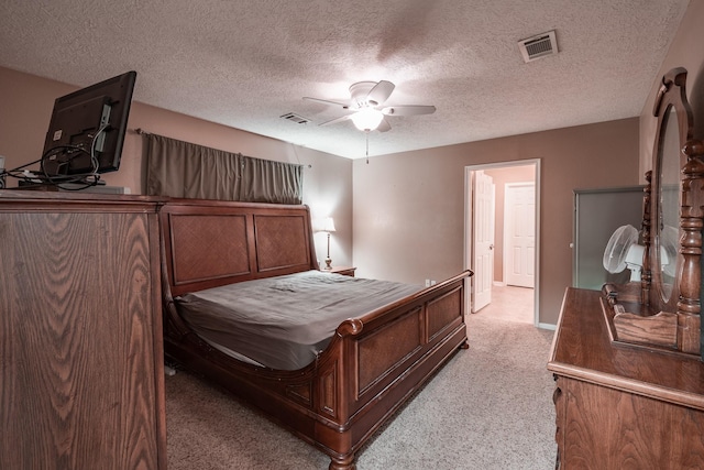 carpeted bedroom featuring a textured ceiling and ceiling fan