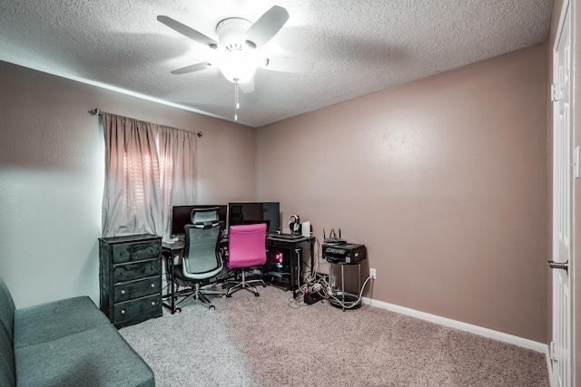 carpeted home office with a textured ceiling and ceiling fan