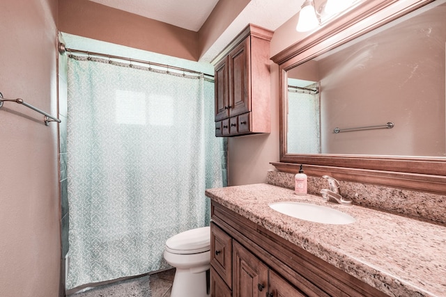 bathroom with vanity, toilet, and walk in shower