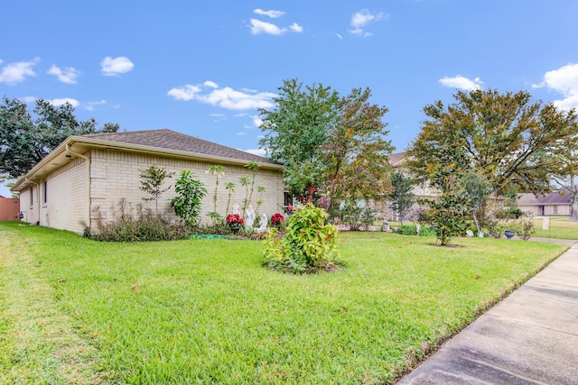 view of side of property with a lawn