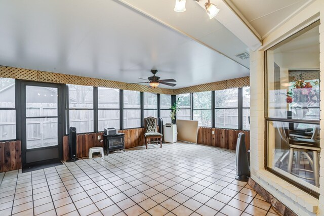 sunroom / solarium featuring ceiling fan