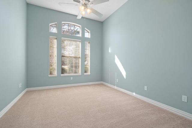 carpeted empty room with ceiling fan