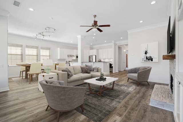 living room featuring ceiling fan, wood-type flooring, and ornamental molding