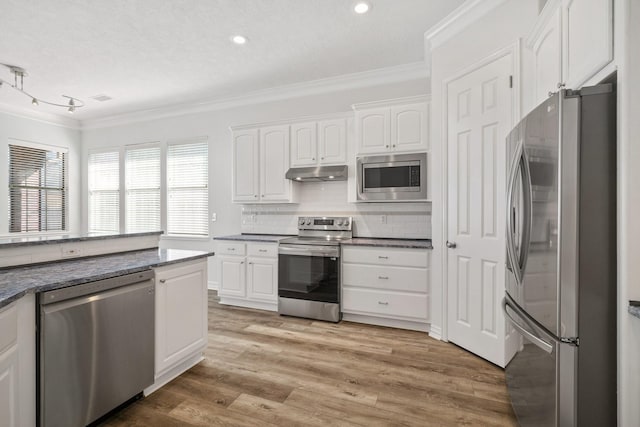 kitchen featuring white cabinets, stainless steel appliances, crown molding, and light hardwood / wood-style floors