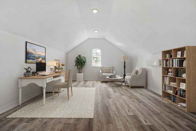 home office featuring hardwood / wood-style floors and lofted ceiling