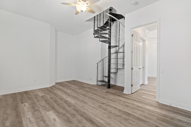 unfurnished living room with ceiling fan and light hardwood / wood-style flooring