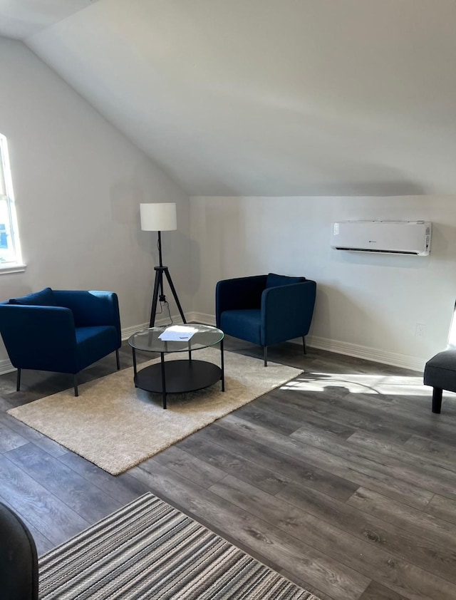 living area featuring lofted ceiling, a wall unit AC, and dark wood-type flooring