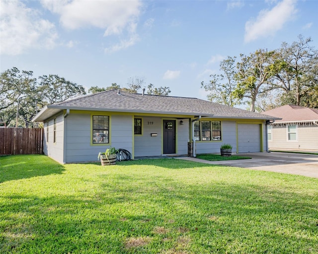 ranch-style house featuring a front yard and a garage