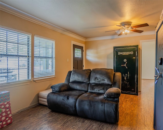 living room featuring ceiling fan, hardwood / wood-style floors, ornamental molding, and a textured ceiling