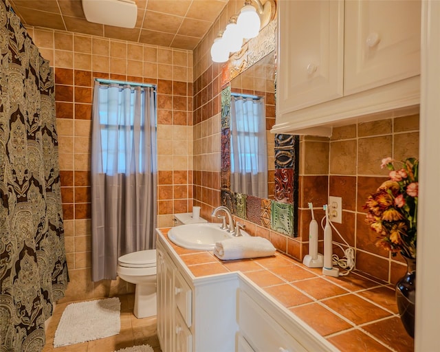 bathroom featuring toilet, vanity, tile walls, and tasteful backsplash