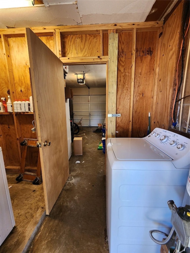 laundry room with washer / clothes dryer and wood walls