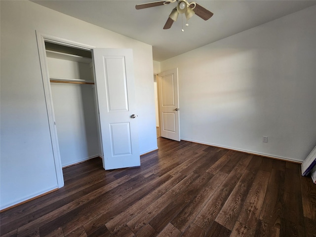 unfurnished bedroom with ceiling fan, dark hardwood / wood-style flooring, and a closet