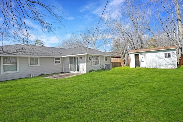 back of property with a patio, central AC, a shed, and a lawn