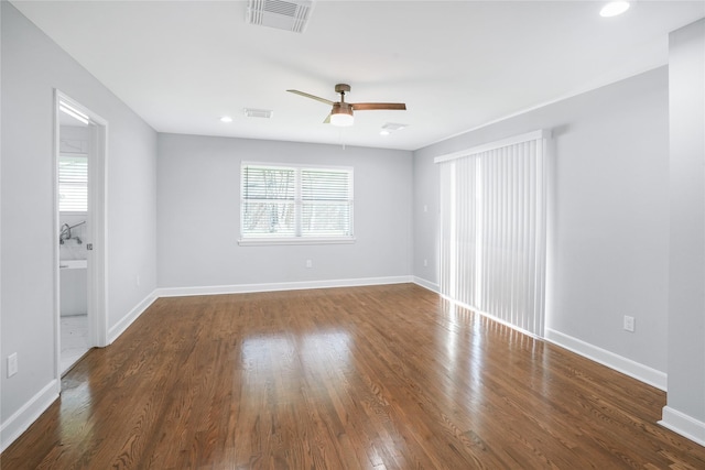 empty room featuring ceiling fan and dark wood-type flooring