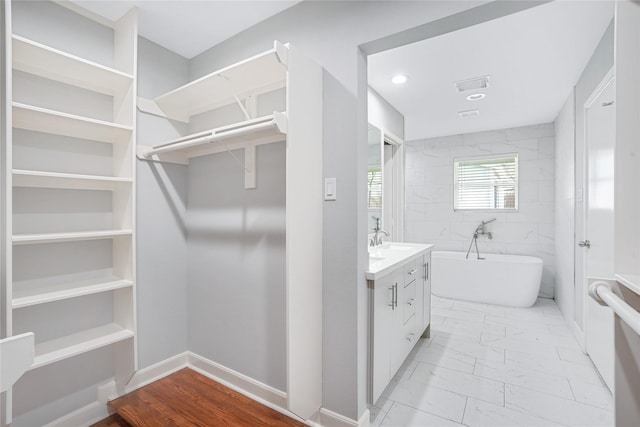 bathroom featuring a tub and vanity