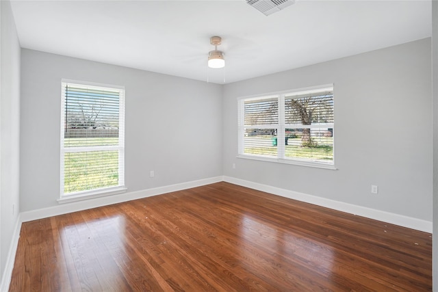 spare room with hardwood / wood-style flooring, plenty of natural light, and ceiling fan