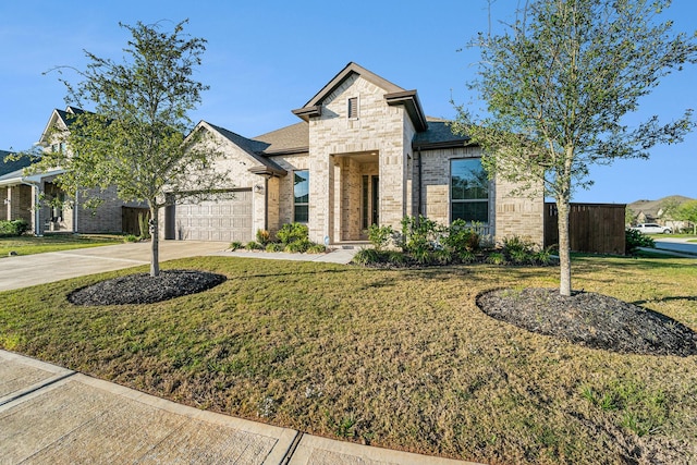 view of front of property featuring a garage and a front lawn