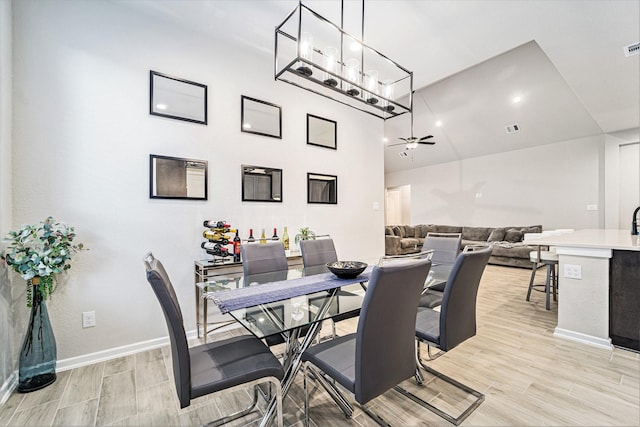 dining room with ceiling fan and light hardwood / wood-style flooring