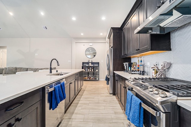 kitchen featuring decorative backsplash, sink, stainless steel appliances, and light wood-type flooring