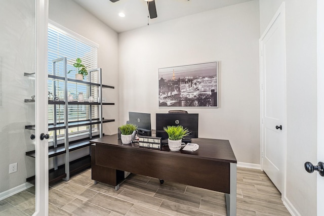 home office with ceiling fan and light hardwood / wood-style floors