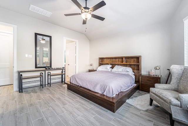 bedroom featuring ceiling fan, light hardwood / wood-style flooring, and lofted ceiling