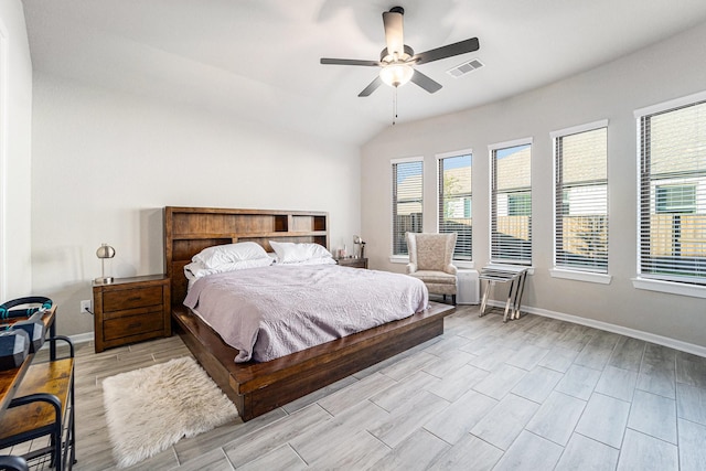 bedroom featuring light wood-type flooring, vaulted ceiling, and ceiling fan