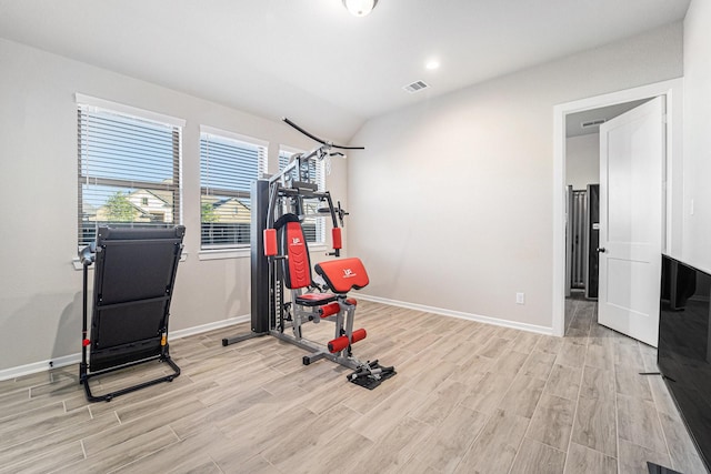 exercise area with lofted ceiling and light hardwood / wood-style flooring