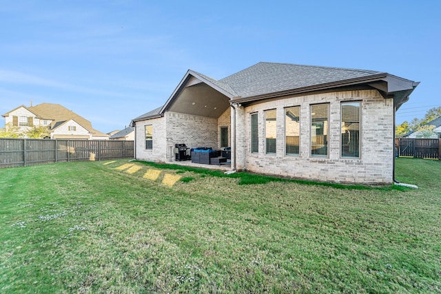 rear view of house with a lawn