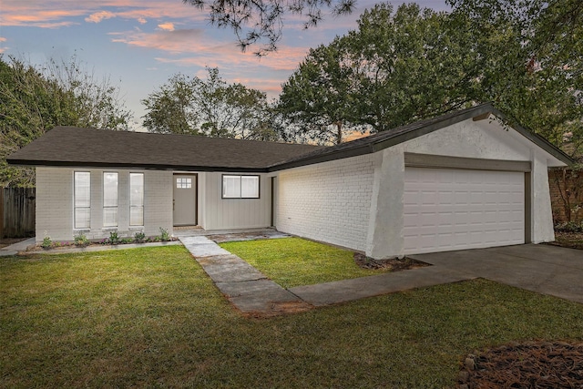 single story home with a yard and a garage