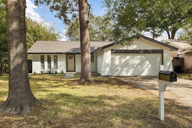 ranch-style house featuring a garage and a front yard