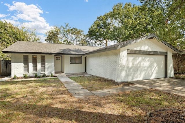 single story home with a front yard and a garage