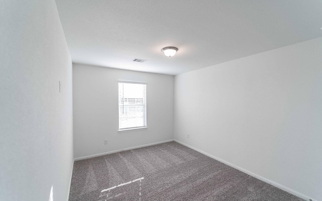 unfurnished room featuring carpet flooring