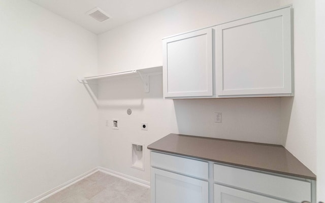 laundry room featuring cabinets, hookup for a washing machine, hookup for an electric dryer, and hookup for a gas dryer