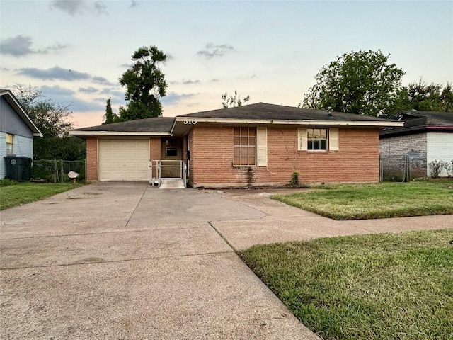 ranch-style home with a lawn and a garage