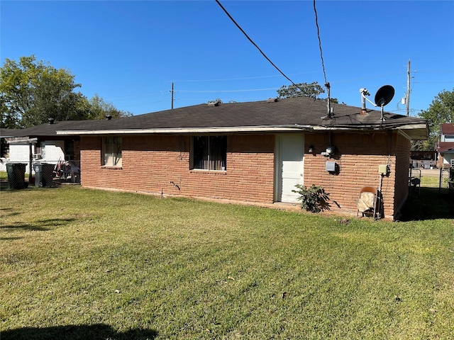 rear view of house featuring a yard