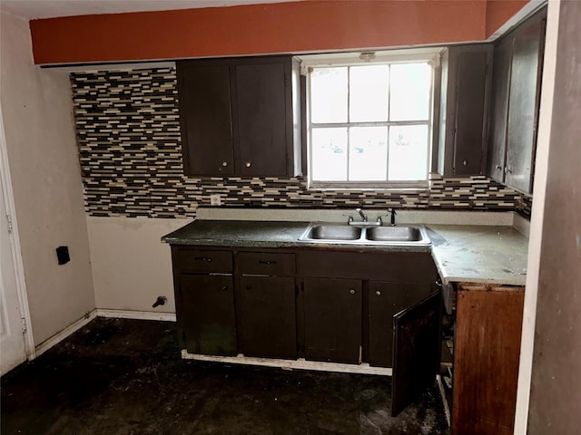 kitchen with dark brown cabinets, sink, and tasteful backsplash