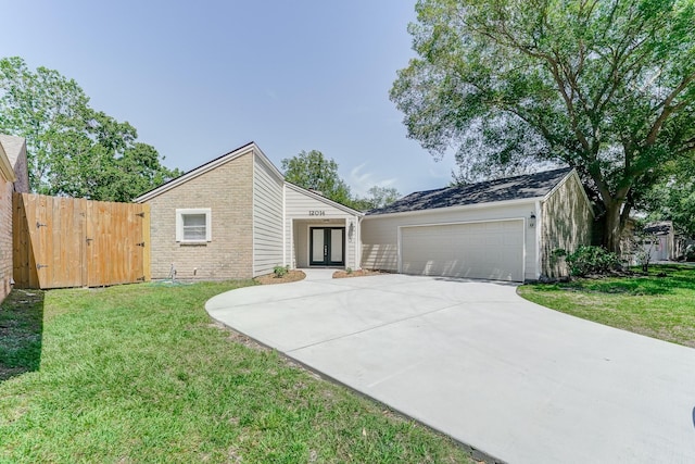 view of front of house with a garage and a front lawn