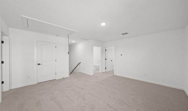 unfurnished room featuring light colored carpet