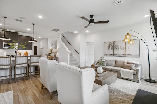 living room with ceiling fan and light hardwood / wood-style floors