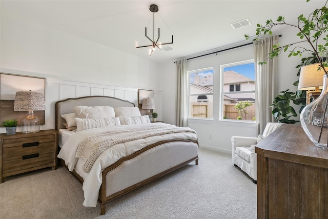 carpeted bedroom featuring a notable chandelier