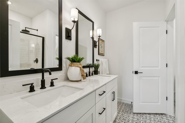 bathroom with tile patterned floors, tiled shower, and vanity