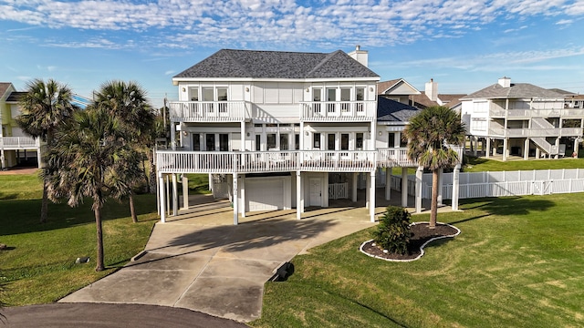 view of front of house with a garage, a balcony, and a front yard