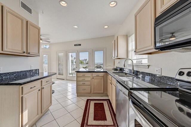 kitchen featuring sink, electric range, stainless steel dishwasher, light brown cabinetry, and light tile patterned flooring