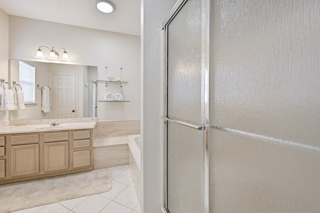 bathroom featuring tile patterned flooring, shower with separate bathtub, and vanity